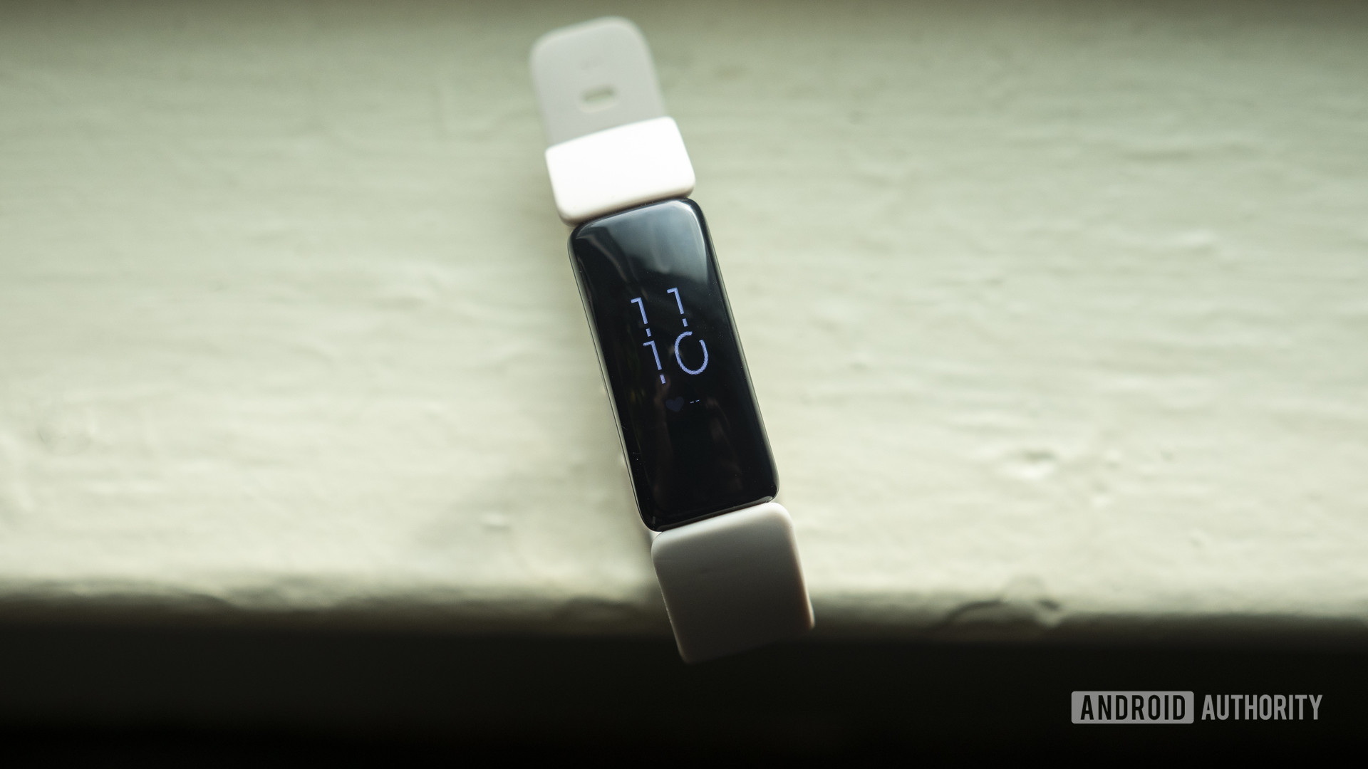 fitbit inspire 2 review fitness tracker display on table 1