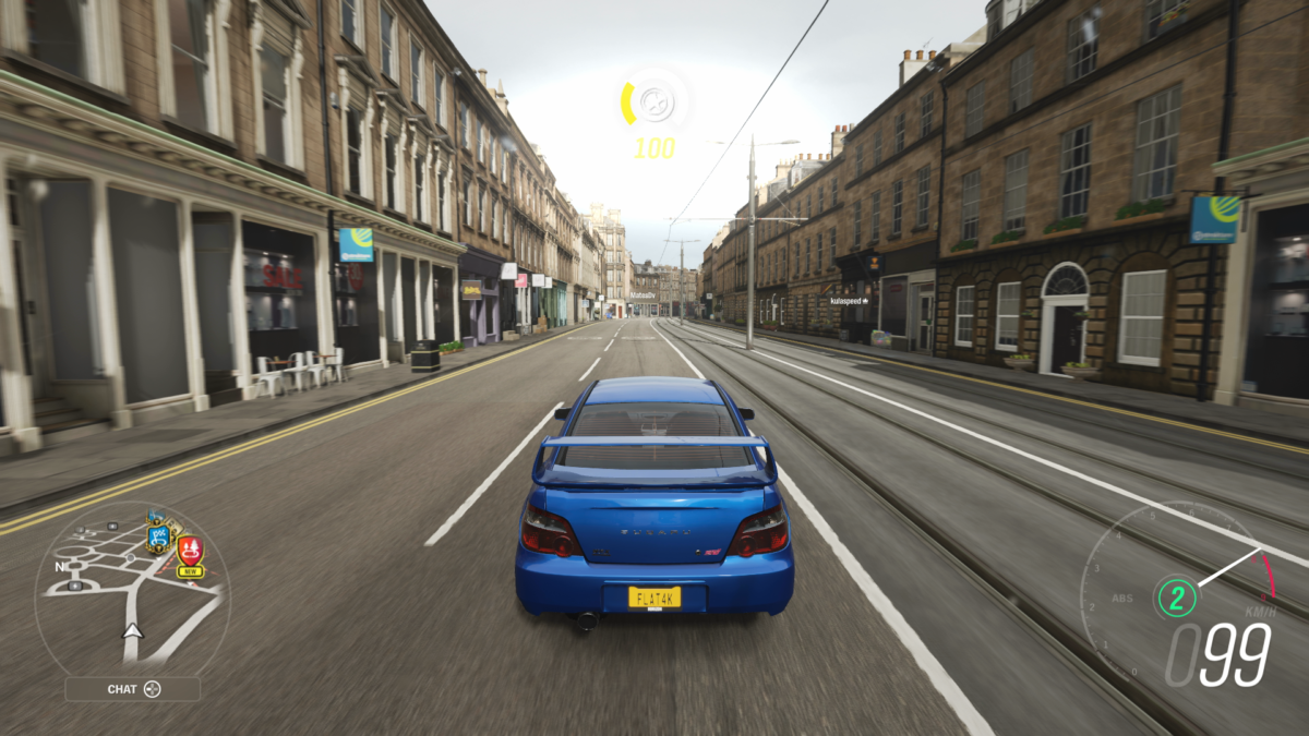 Xbox Series S screenshot of Forza Horizon 4 with a Subaru driving through the city