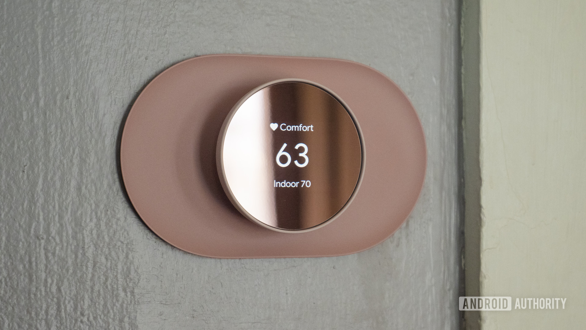 Checking the Google Nest thermostat shows the temperature on the wall 3