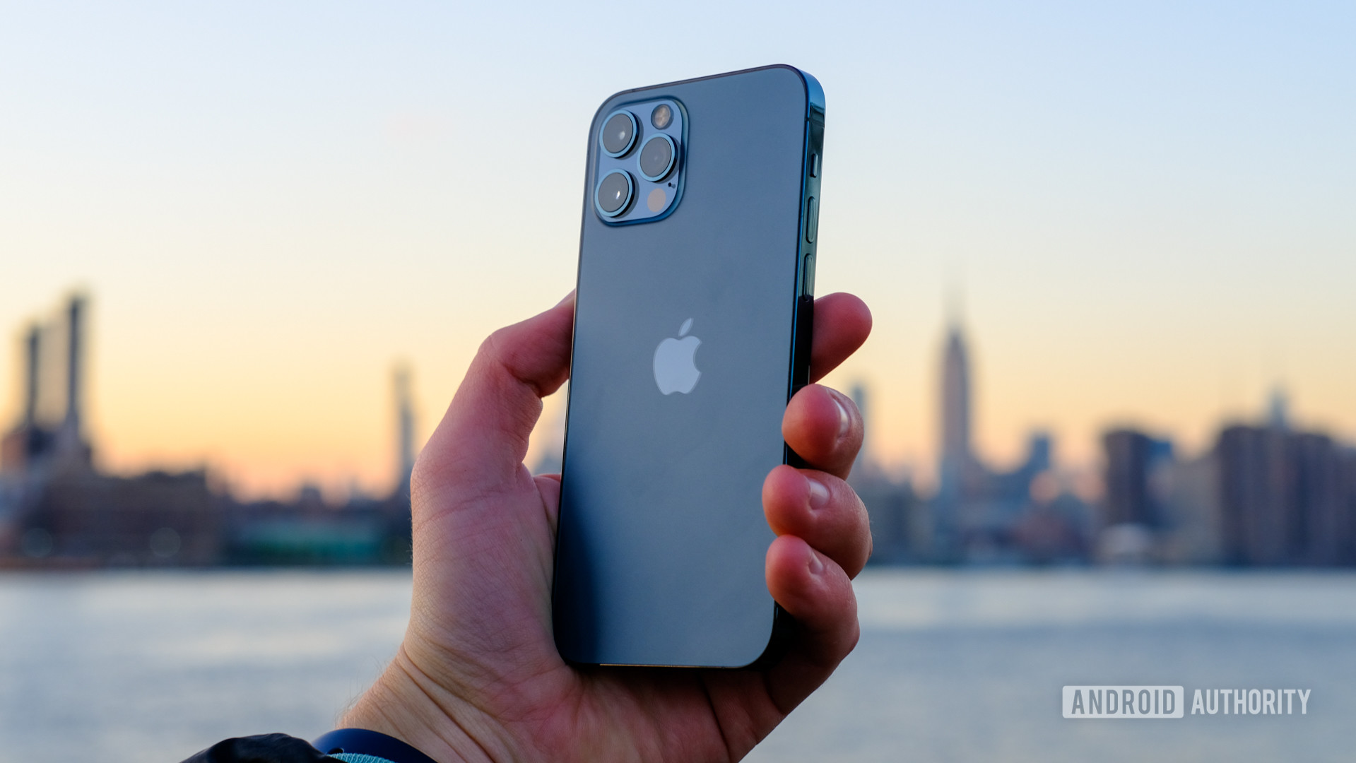 iPhone 12 Pro holding bakc of phone against sunset