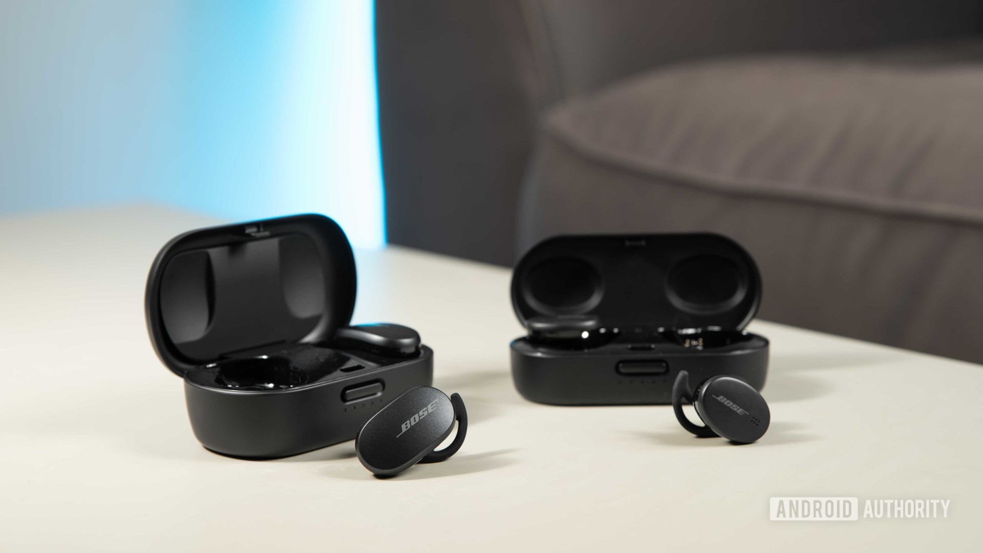 The Bose QuietComfort Earbuds noise cancelling true wireless earbuds next to the Bose Sport Earbuds for a size comparison.