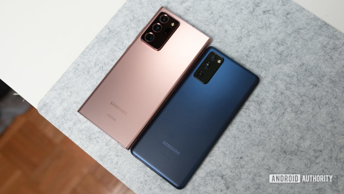 Samsung Galaxy S20 FE 5G in blue next to Samsung Galaxy Note 20 Ultra on a gray felt deskpad.