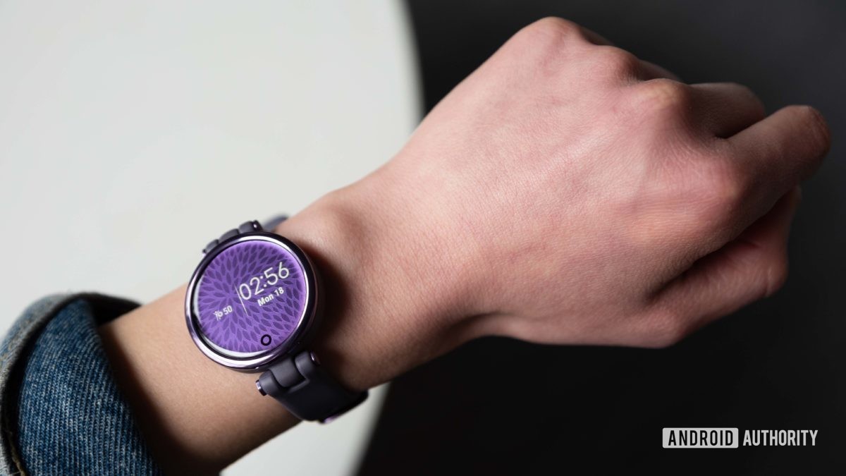 The Garmin Lily Sport Edition smart watch displays the time on a woman's wrist.