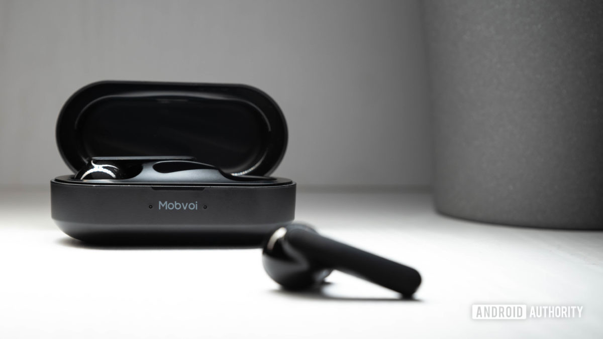 The Mobvoi Earbuds Gesture true wireless earbuds case open with a blurred out earbud in the foreground.