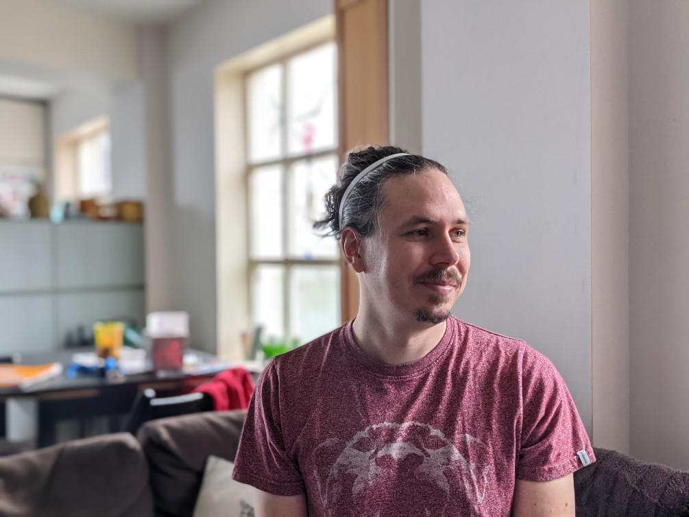 Portrait Indoor Google Pixel 5 of a man in a red t-shirt with dark hair tied back
