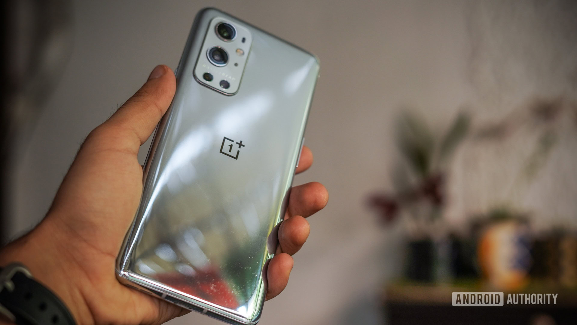 The OnePlus 9 Pro in hand showing back.