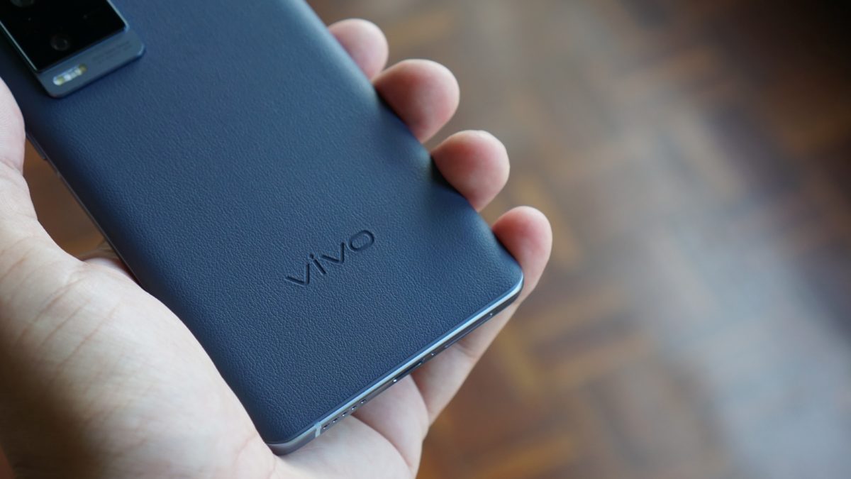 Vivo X60 Pro Plus in hand showing the rear of phone and logo
