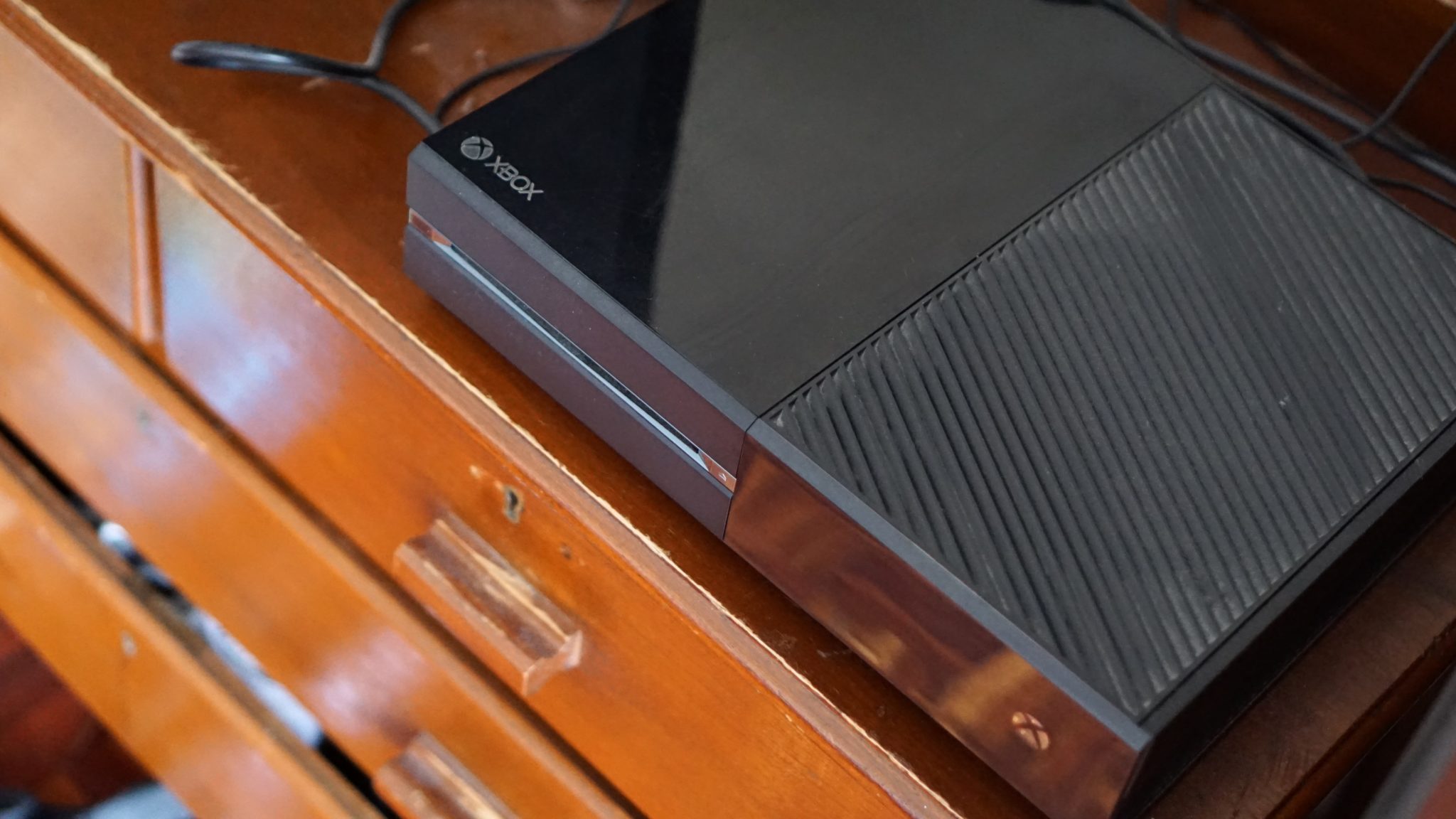 Xbox One on a chest of drawers.