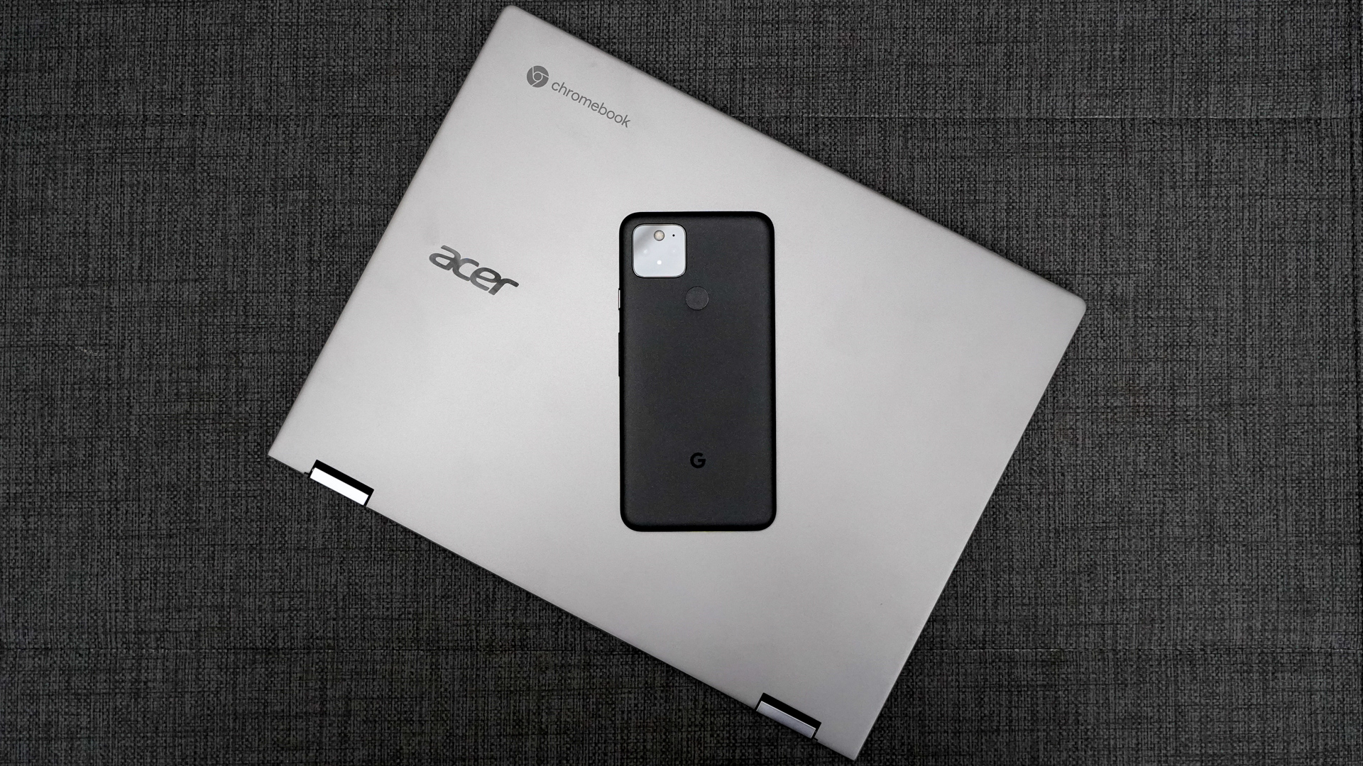 The Acer Chromebook Spin 713 with a phone on top of the laptop.