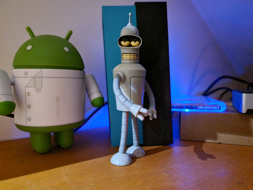 Android and Bender figurines in the dark taken on Samsung Galaxy S21 Ultra