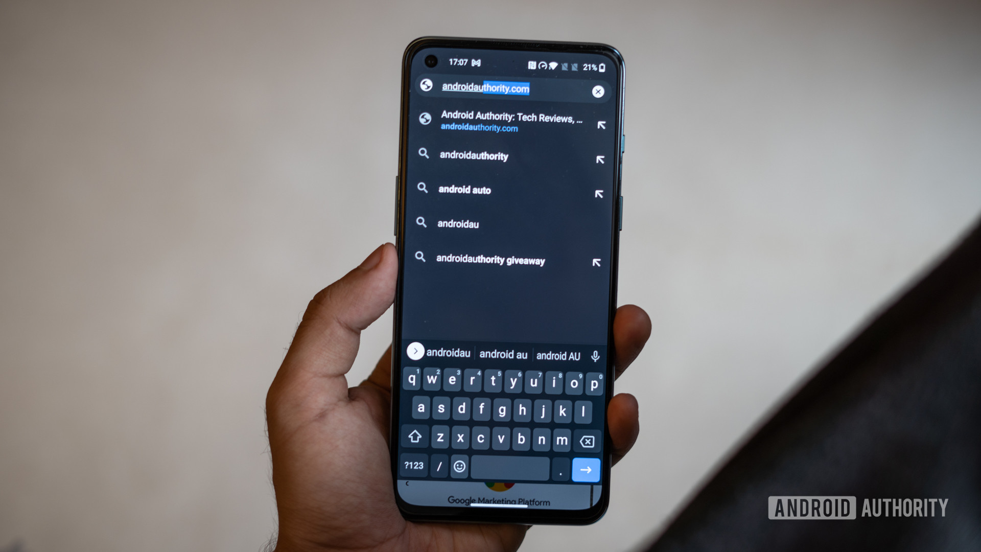 OnePlus Nord 2 in hand showing keyboard