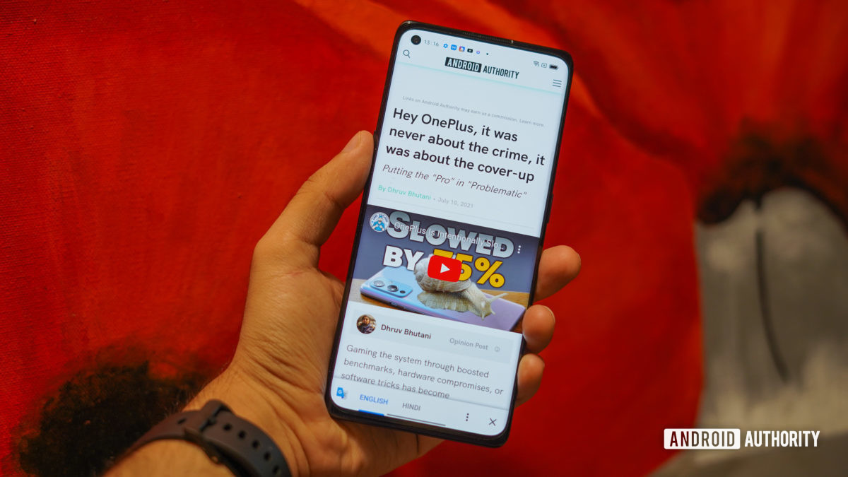 The Oppo Reno 6 Pro review in hand showing the screen with web page open.