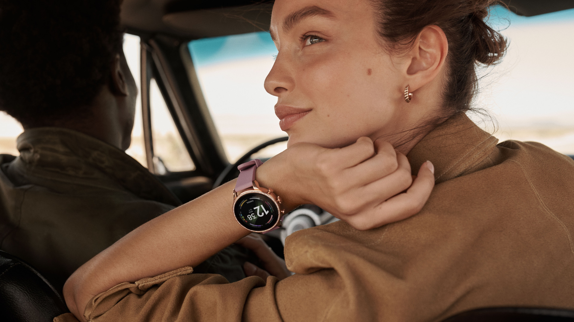The Fossil Gen 6 Smartwatch rose gold with a silicone strap on a women's wrist.