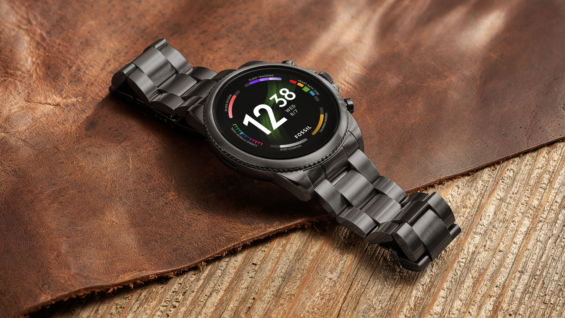 The Fossil Gen 6 Smartwatch with a stainless steel strap on a table.