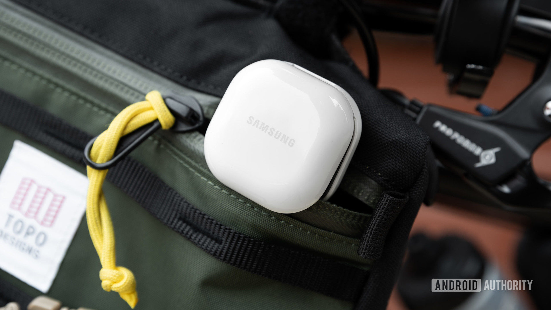 The Samsung Galaxy Buds 2 noise cancelling true wireless earbuds case partway in a zippered bag.