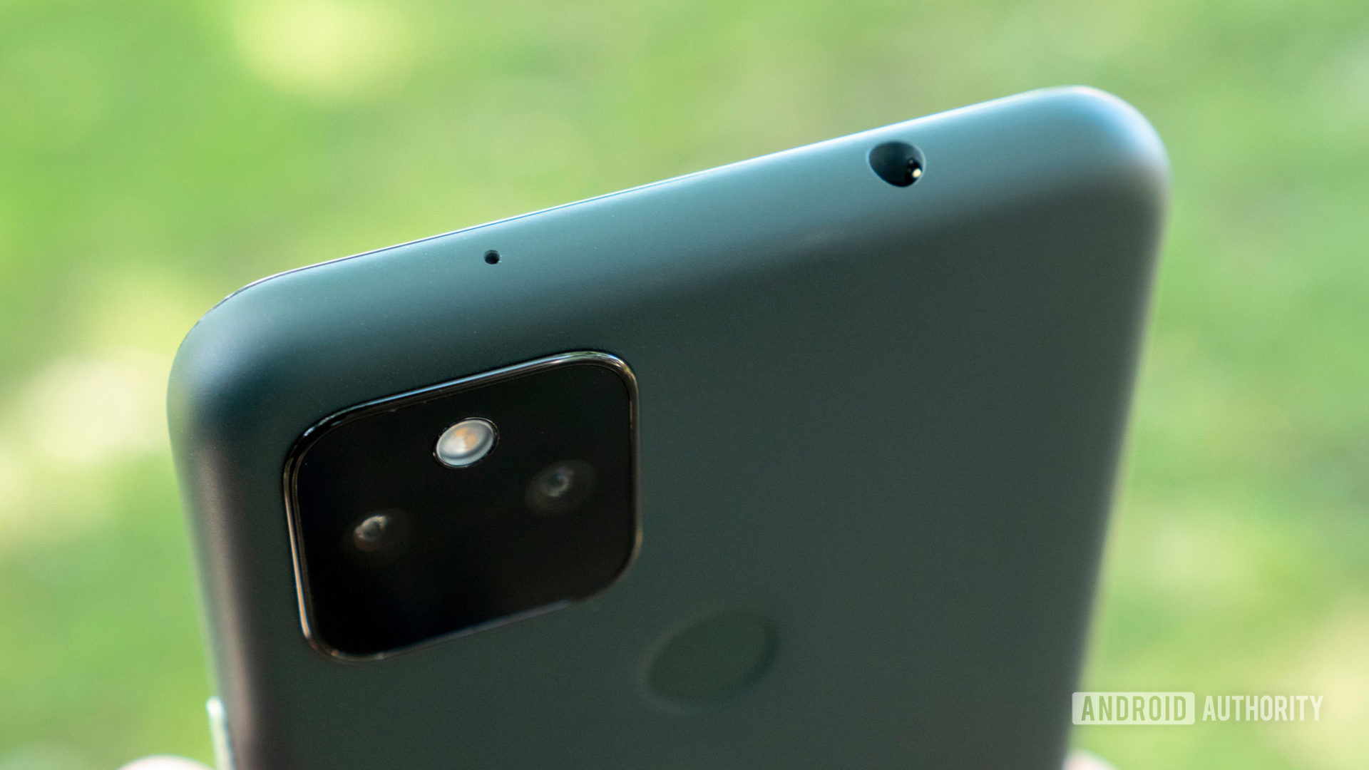 The Google Pixel 5a tilted showing the camera module and headphone jack.