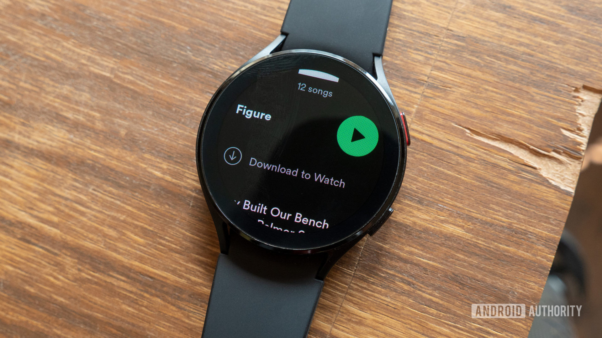 The Samsung Galaxy Watch 4 on a desk showing how to download Spotify music to Wear OS.