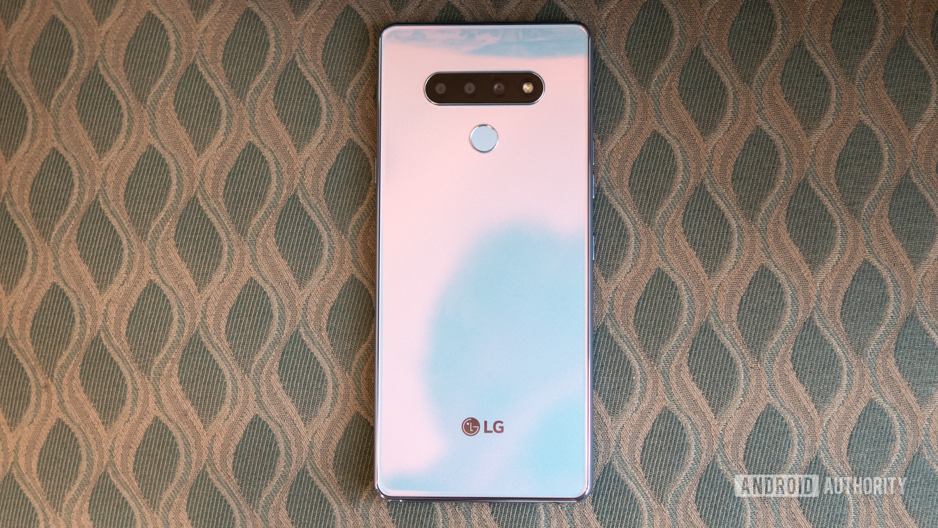 LG Stylo 6 back panel on a patterned chair