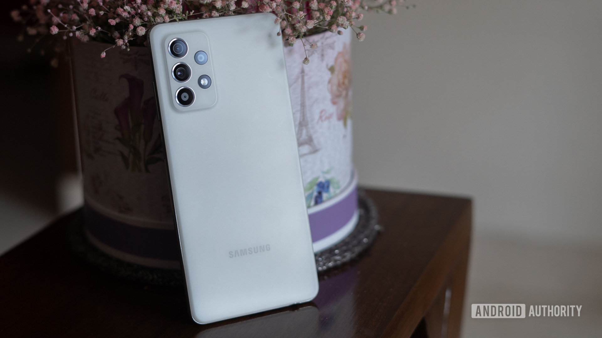Samsung Galaxy A52s 5G angled up against flower pot