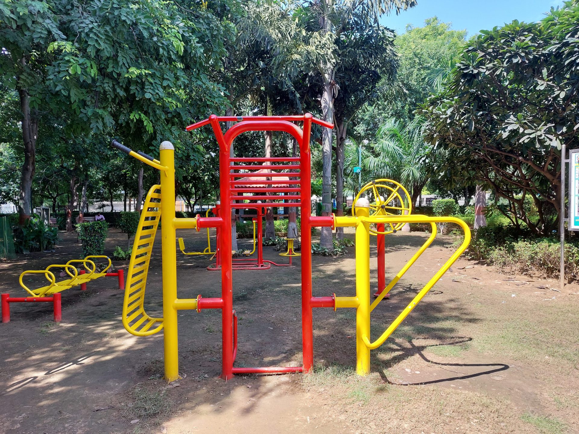 Samsung Galaxy A52s 5G bright outdoor shot of a red and yellow climbing frame in a park.
