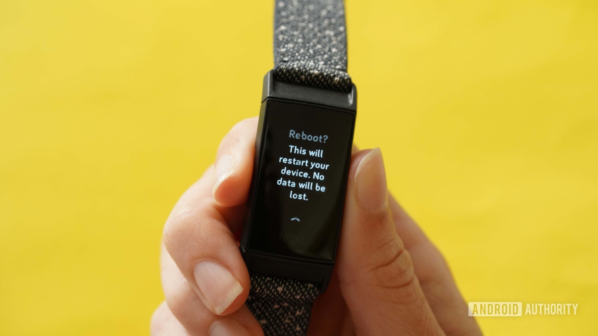 A users shows how to restart a Fitbit Charge 4.