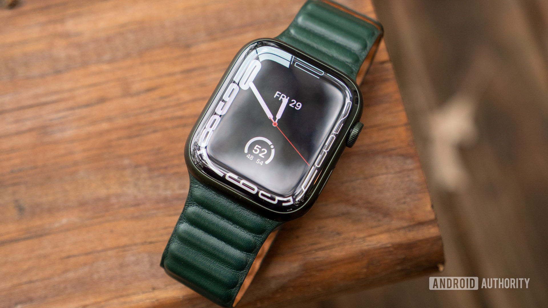An image of the Apple Watch Series 7 showing the Contour watch face on a table