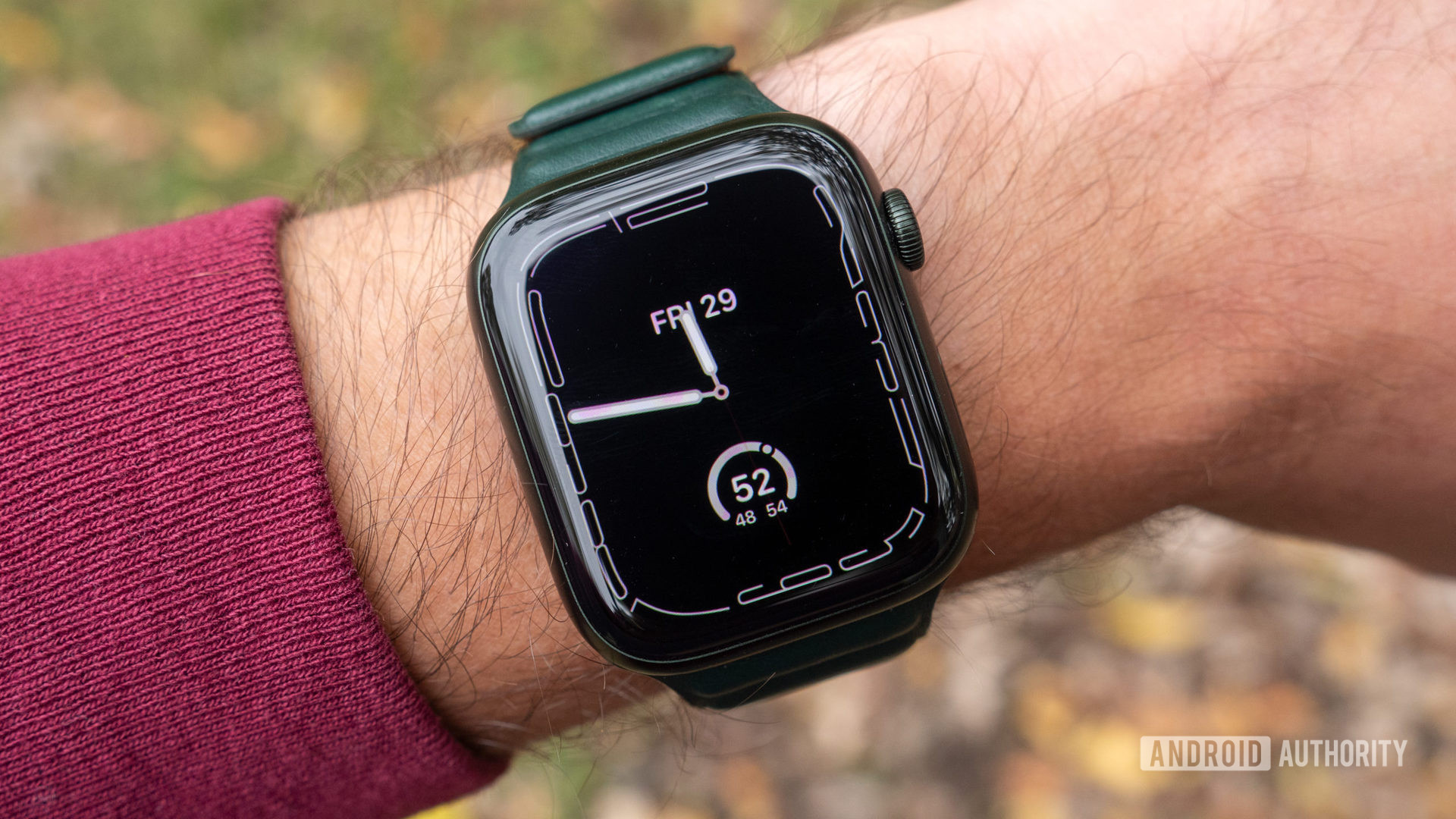 An image of the Apple Watch Series 7 on a wrist showing the Contour watch face always-on display