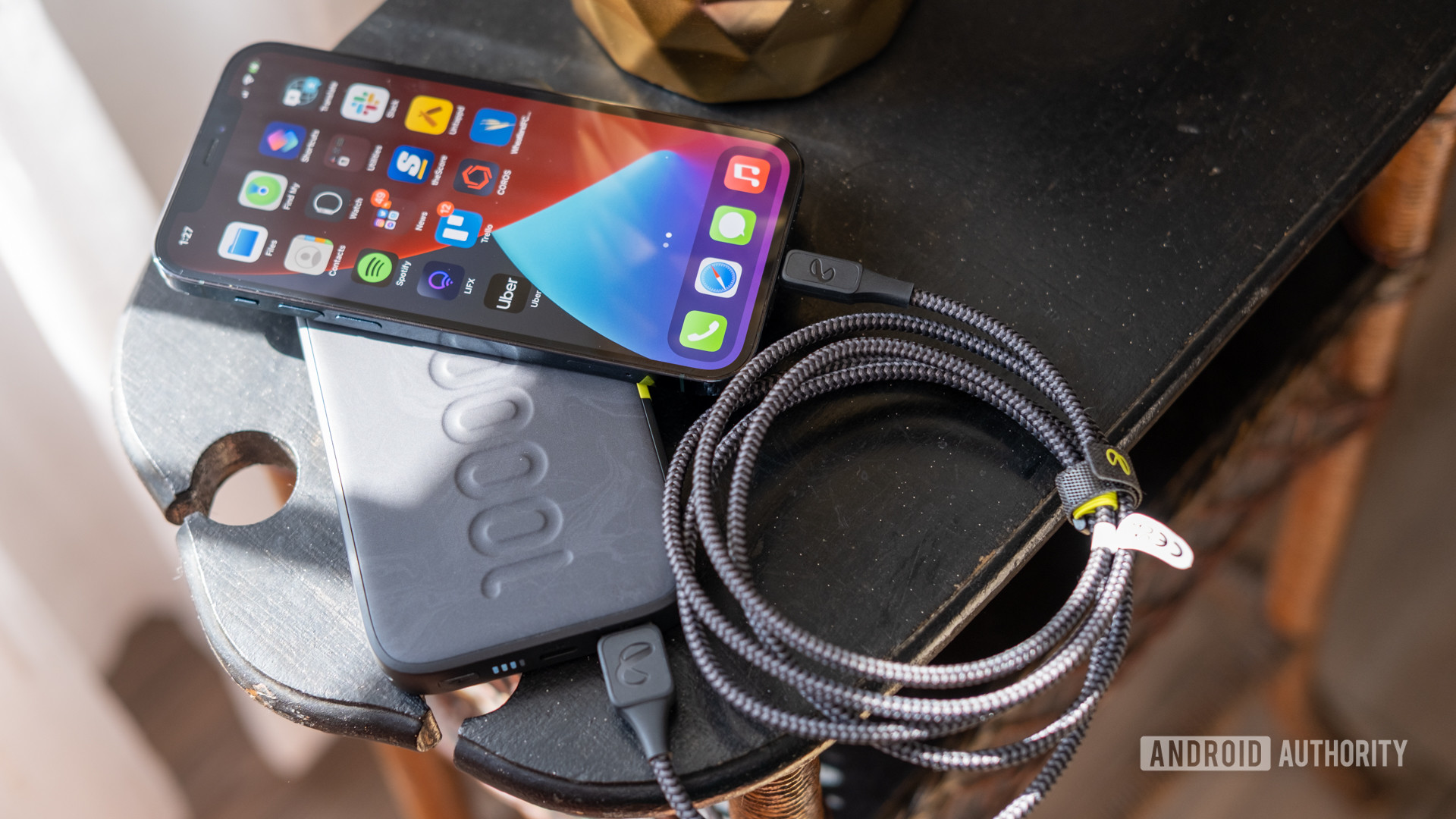 The InfinityLab InstantGo power bank charging an iPhone 12 Pro