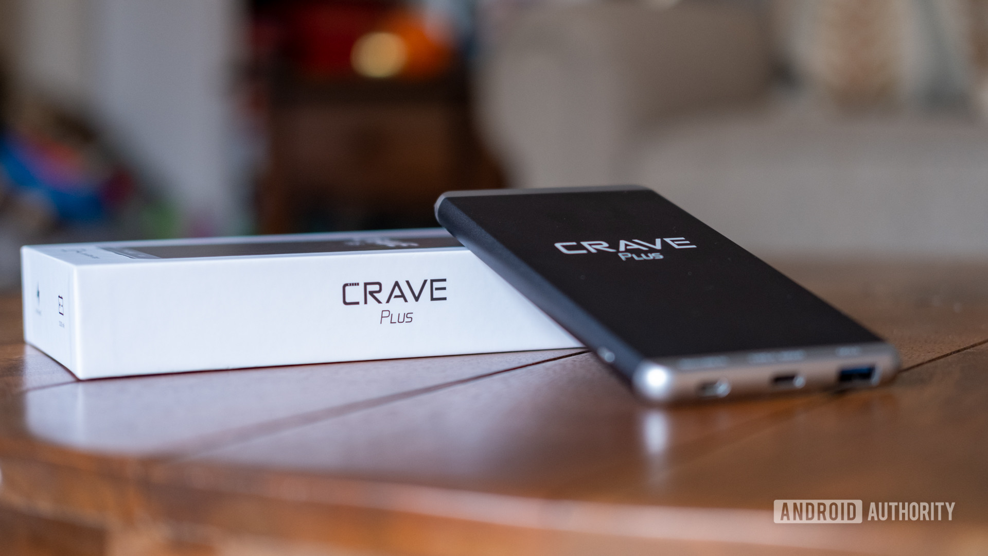 The Crave Plus leaning on its box