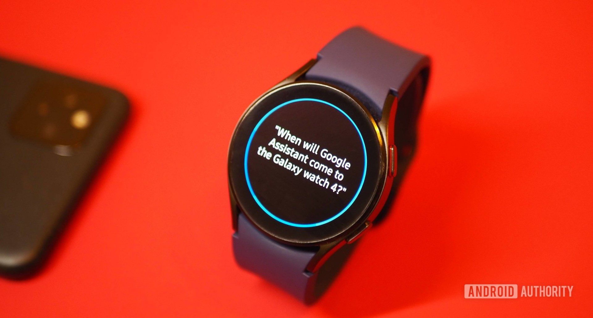 Samsung Galaxy Watch 4 on red background, showing Bixby question about Google Assistant