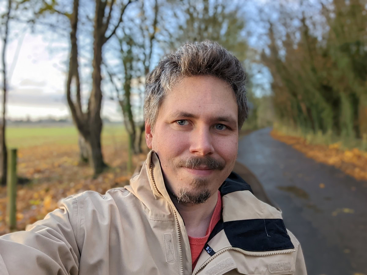 Outdoor selfie on a cold day with trees in the background shot on Google Pixel 6 Pro
