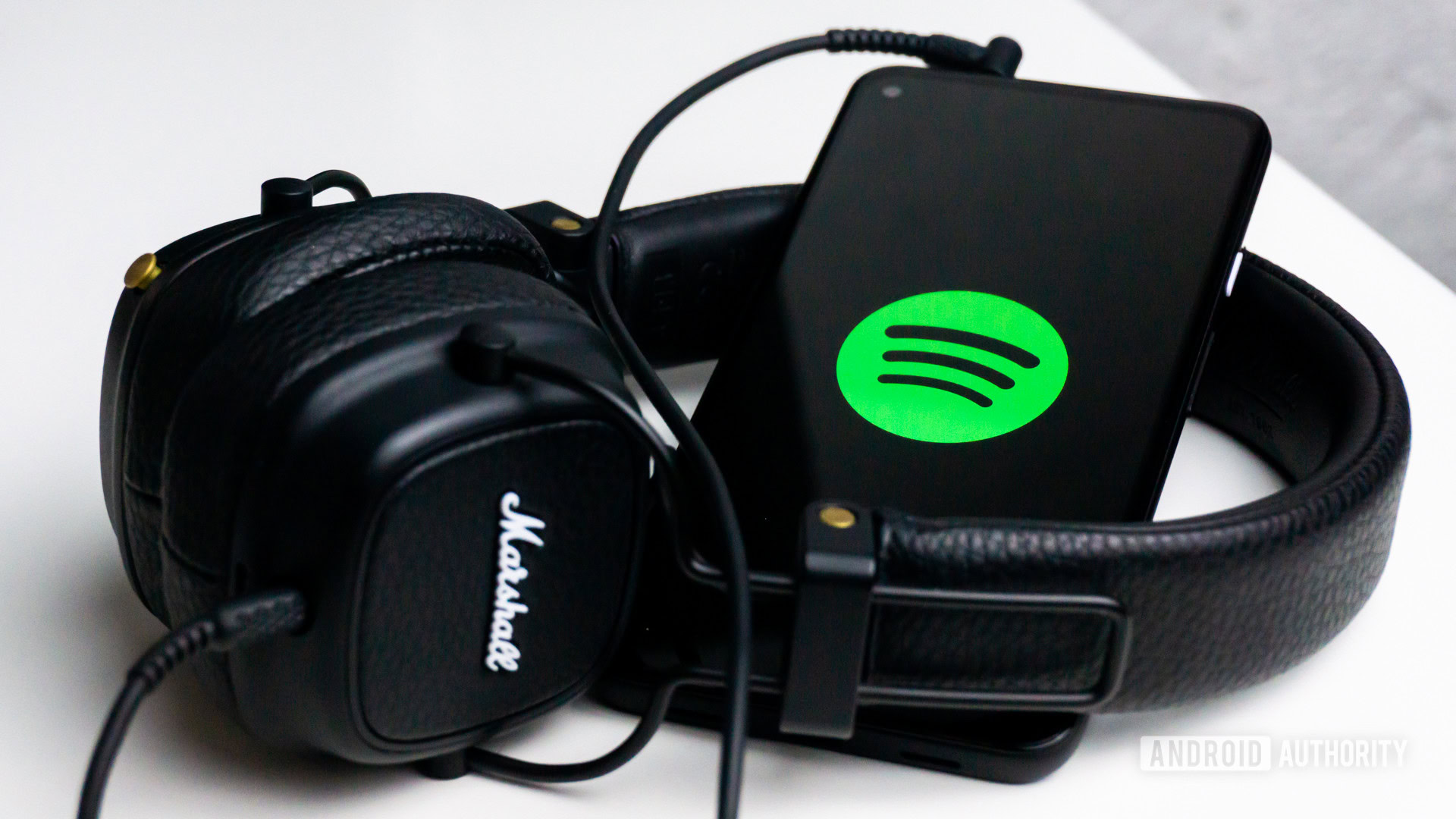 Spotify on mobile with a pair of headphones