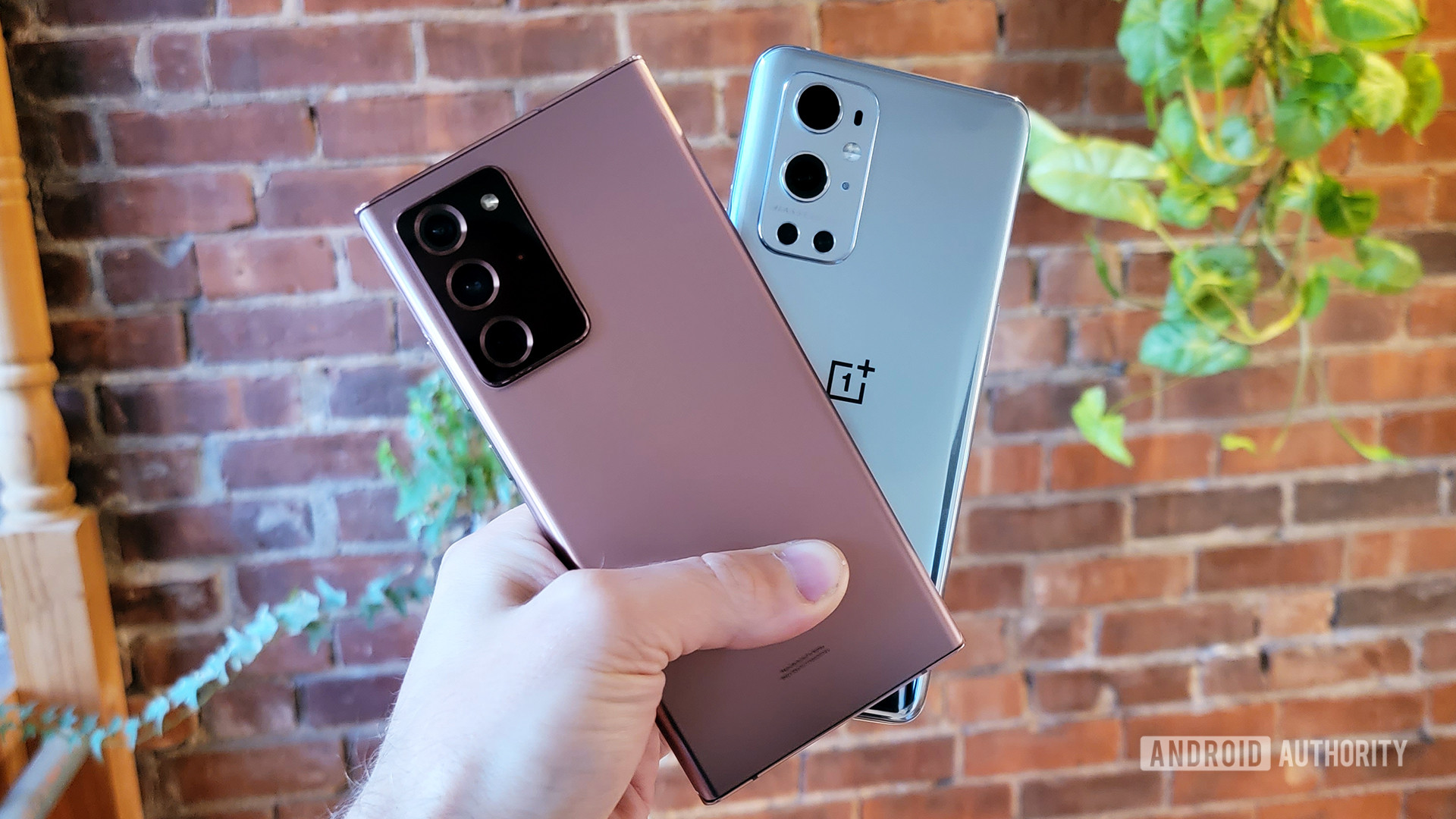 A samsung galaxy note 20 ultra and oneplus 9 pro in a person's hand
